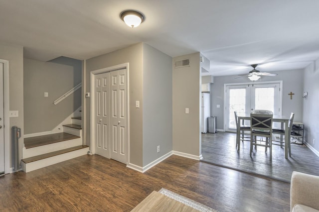 dining space with ceiling fan, dark wood-type flooring, and french doors