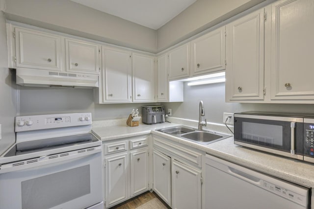 kitchen featuring white cabinetry, white appliances, and sink