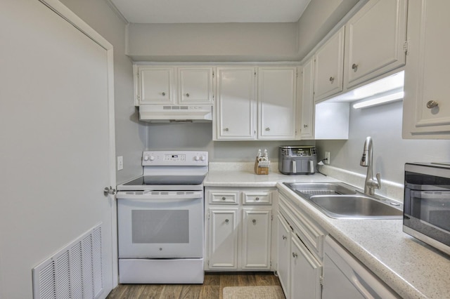 kitchen with electric range, dark hardwood / wood-style flooring, white cabinetry, and sink