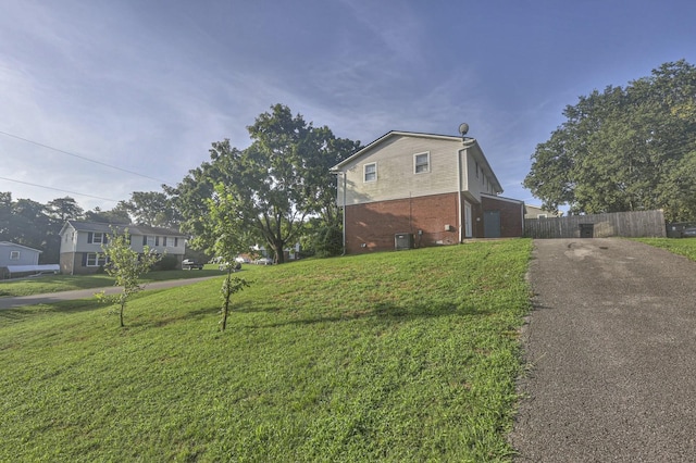 view of side of property with a lawn