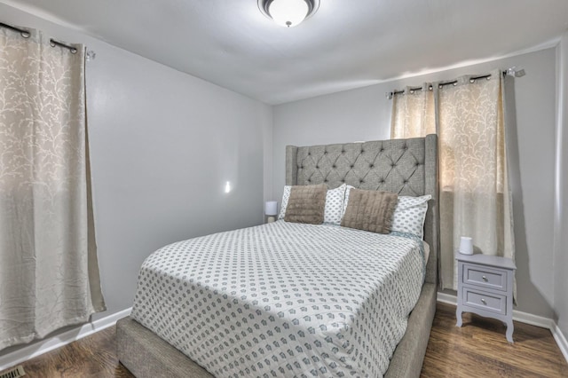 bedroom with dark wood-type flooring