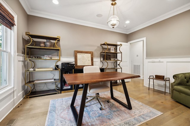 office space with light hardwood / wood-style floors and ornamental molding