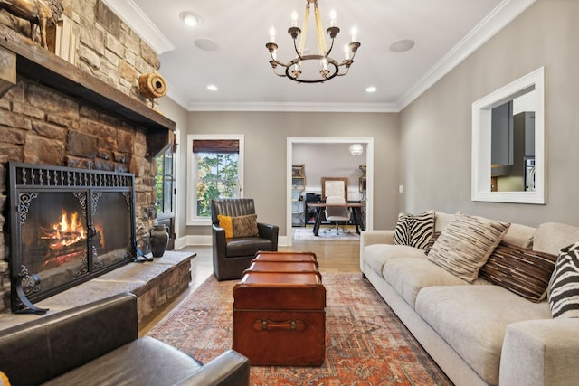 living room with hardwood / wood-style floors, a stone fireplace, crown molding, and a chandelier