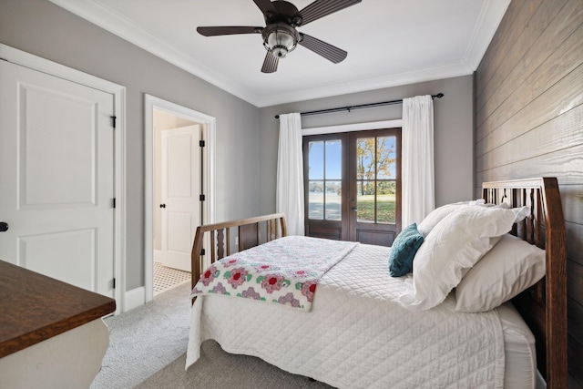 bedroom featuring ceiling fan, french doors, wooden walls, carpet, and ornamental molding