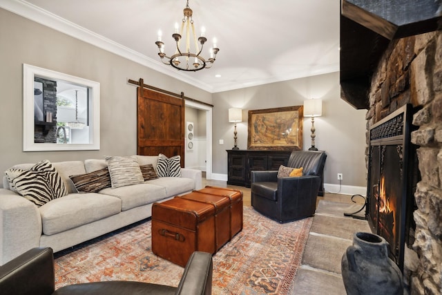 living room with a barn door, a stone fireplace, a notable chandelier, and ornamental molding