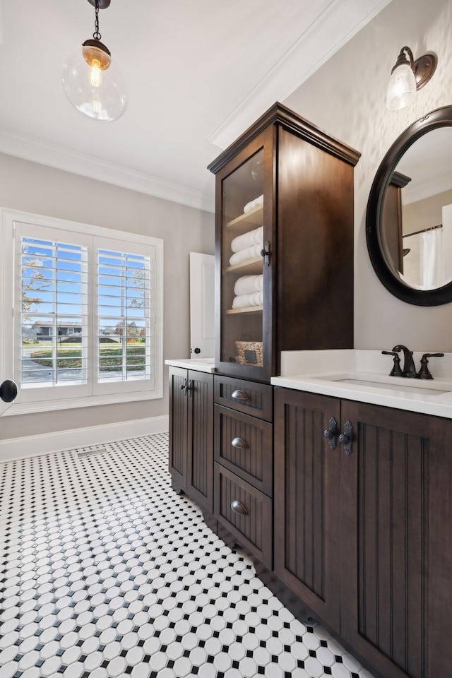 bathroom featuring crown molding and vanity