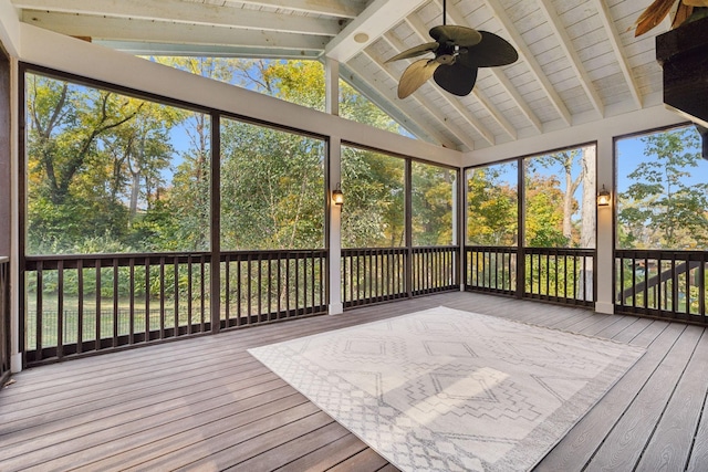 unfurnished sunroom with vaulted ceiling with beams and ceiling fan