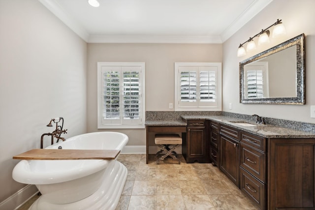 bathroom with a bathing tub, vanity, and ornamental molding