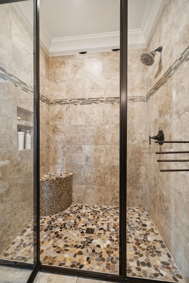 bathroom featuring a tile shower and ornamental molding