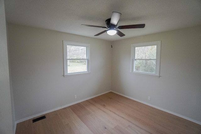 spare room with ceiling fan and light hardwood / wood-style floors