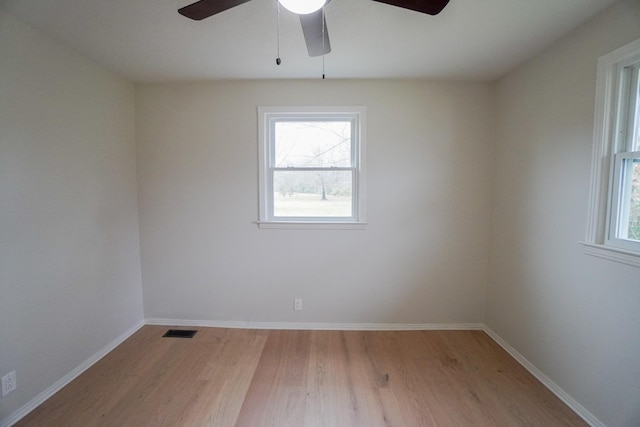 spare room with light wood-type flooring and ceiling fan