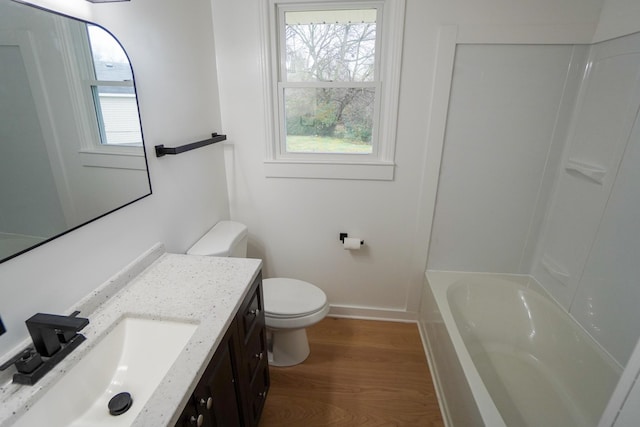 bathroom with vanity, hardwood / wood-style flooring, and toilet