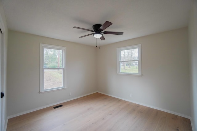 empty room featuring ceiling fan and light wood-type flooring