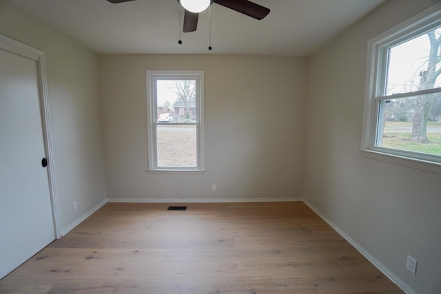 empty room featuring ceiling fan and light wood-type flooring