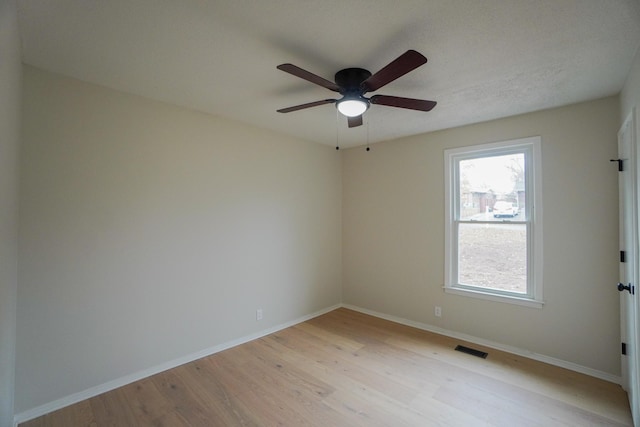 spare room with ceiling fan and light hardwood / wood-style floors