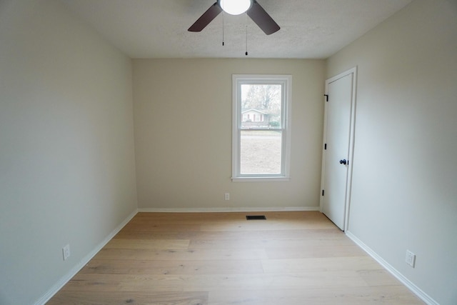 spare room with ceiling fan and light wood-type flooring