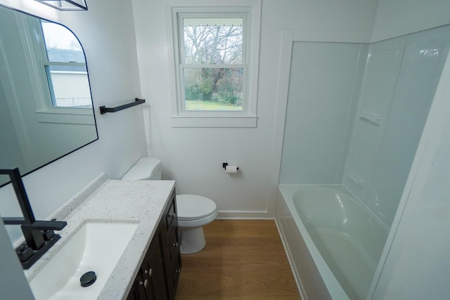 bathroom with hardwood / wood-style flooring, vanity, and toilet