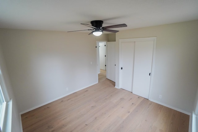 unfurnished bedroom with ceiling fan, a closet, and light hardwood / wood-style flooring