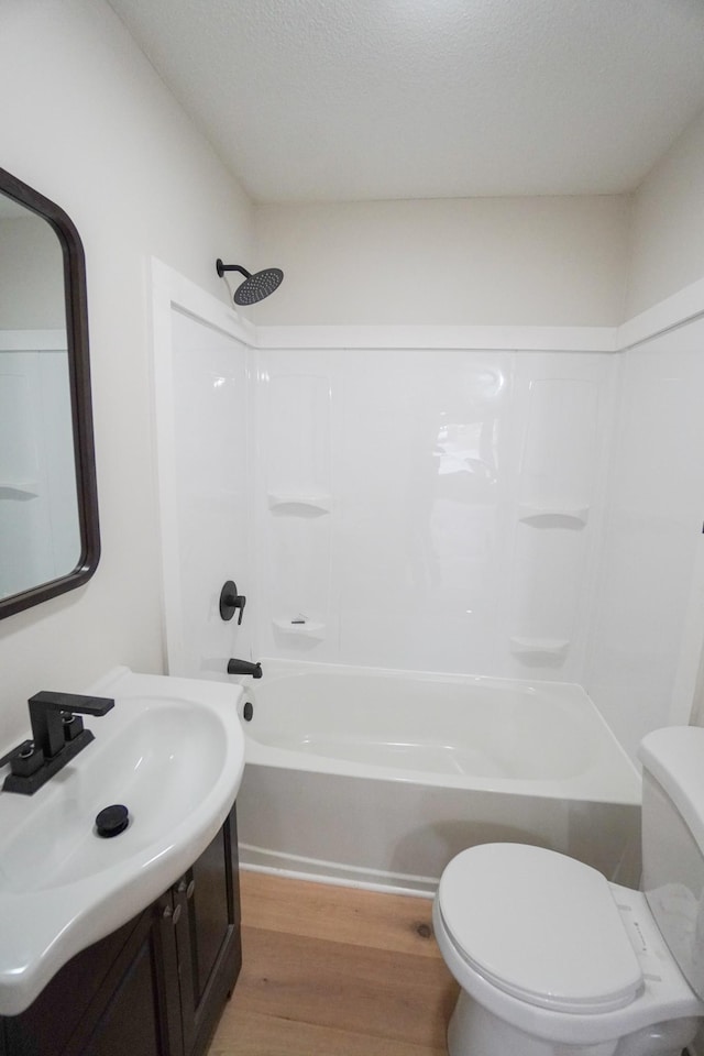 full bathroom featuring hardwood / wood-style flooring, vanity, toilet, and shower / bathing tub combination