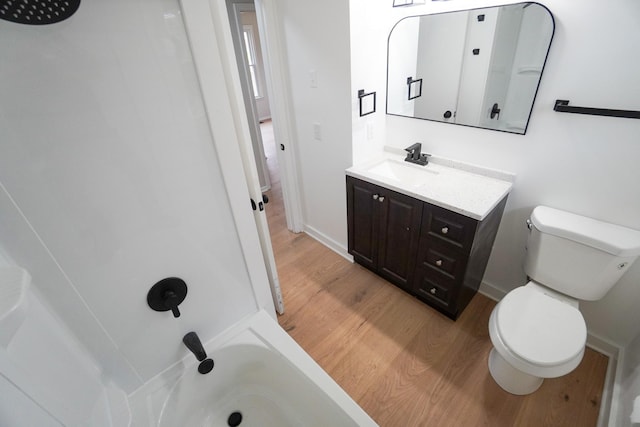 bathroom with hardwood / wood-style floors, vanity, and toilet