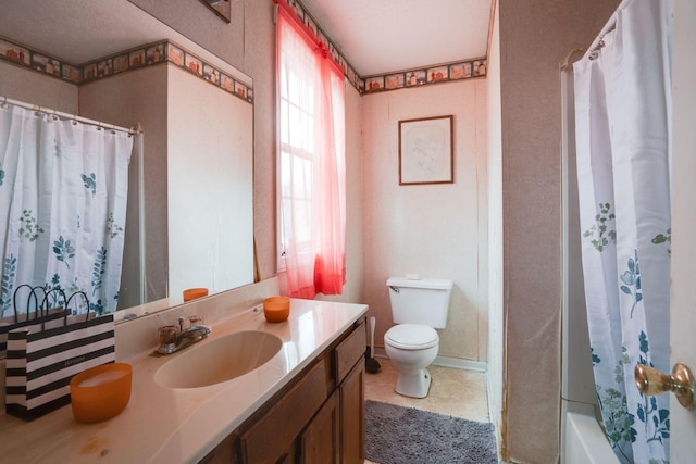 full bathroom featuring toilet, vanity, a textured ceiling, and shower / bathtub combination with curtain