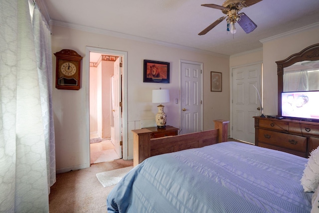 carpeted bedroom featuring ceiling fan, ensuite bathroom, and crown molding