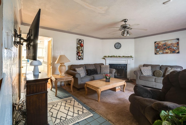 tiled living room featuring ceiling fan, a textured ceiling, and ornamental molding