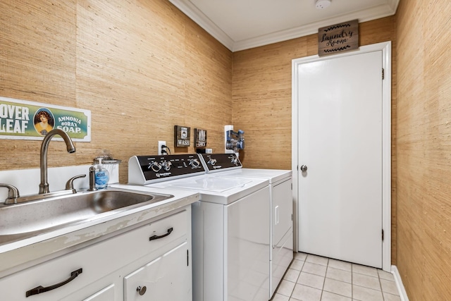 laundry room featuring sink, cabinets, washing machine and dryer, wooden walls, and light tile patterned flooring