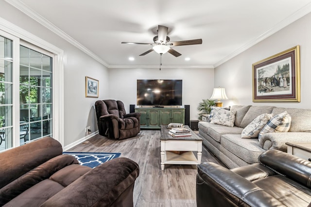 living room with light hardwood / wood-style flooring, ceiling fan, and ornamental molding