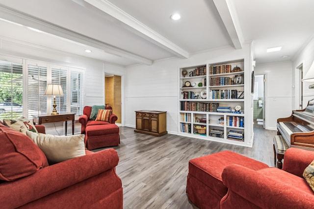 living room featuring beam ceiling, ornamental molding, and hardwood / wood-style flooring