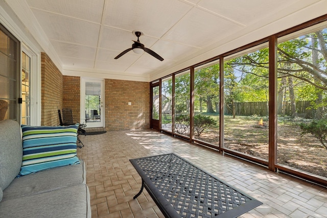 sunroom with ceiling fan and plenty of natural light