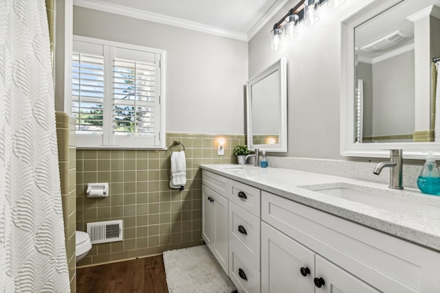 bathroom with vanity, hardwood / wood-style flooring, tile walls, and crown molding