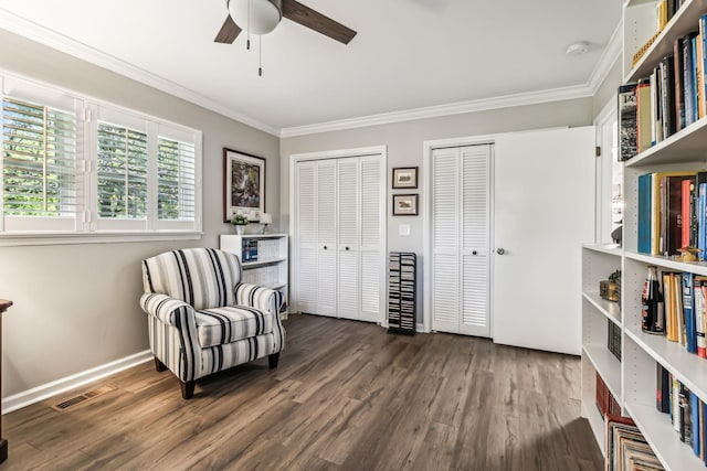 living area with ceiling fan, dark hardwood / wood-style flooring, and crown molding