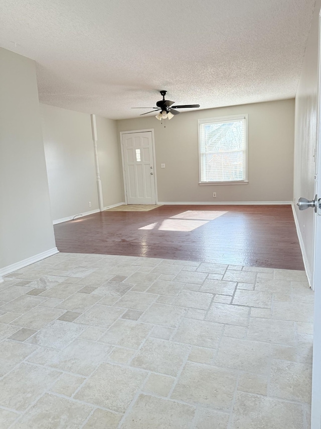 spare room with ceiling fan and a textured ceiling