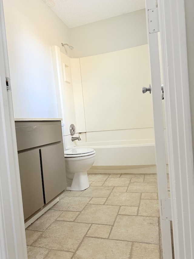 bathroom featuring shower / bathtub combination, a textured ceiling, and toilet