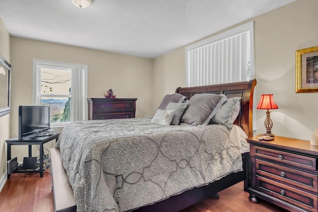 bedroom with hardwood / wood-style flooring