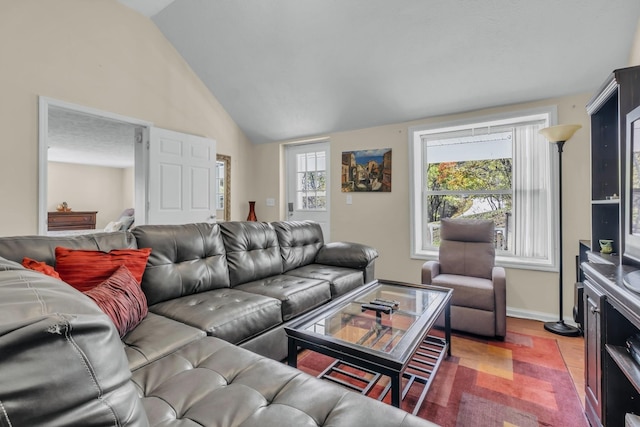 living room with plenty of natural light and lofted ceiling