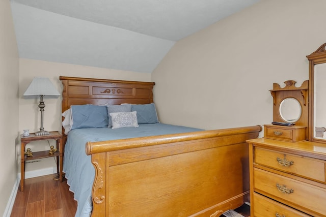 bedroom with hardwood / wood-style floors and vaulted ceiling