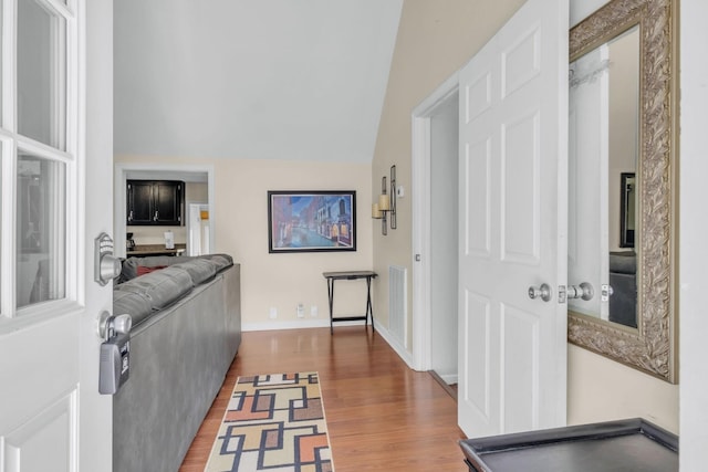 interior space featuring hardwood / wood-style flooring and lofted ceiling