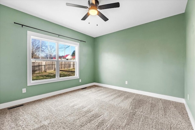 unfurnished room with ceiling fan and carpet floors