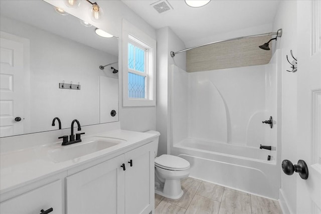 full bathroom with vanity, bathing tub / shower combination, and toilet