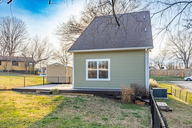 view of home's exterior featuring cooling unit and a yard