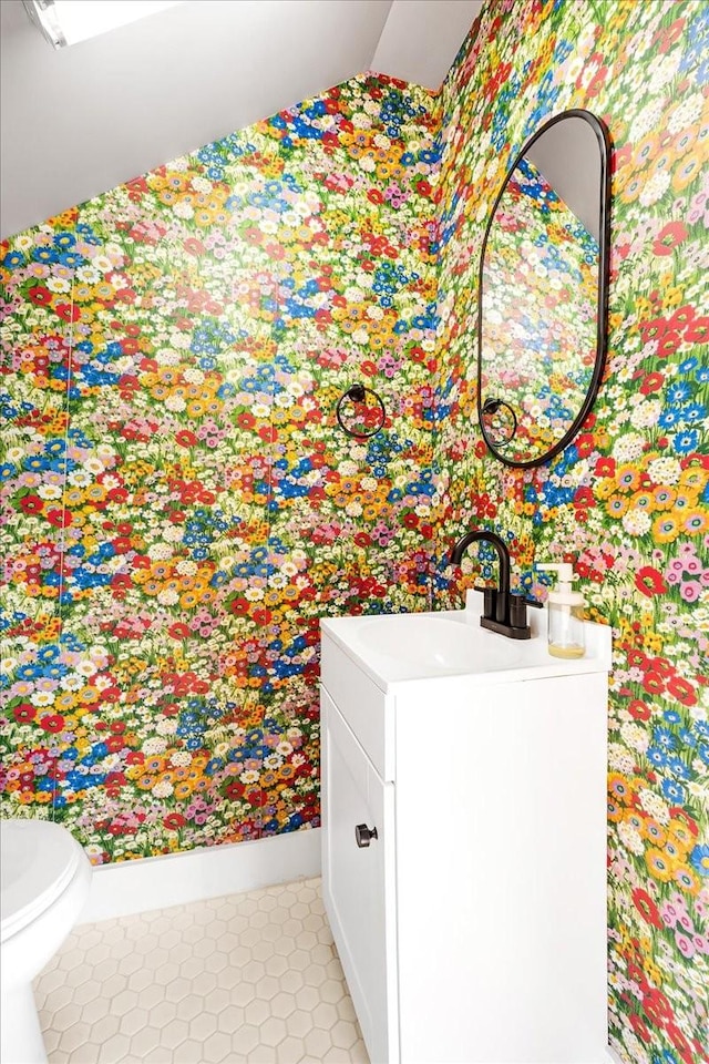 bathroom with tile patterned flooring, vanity, and toilet