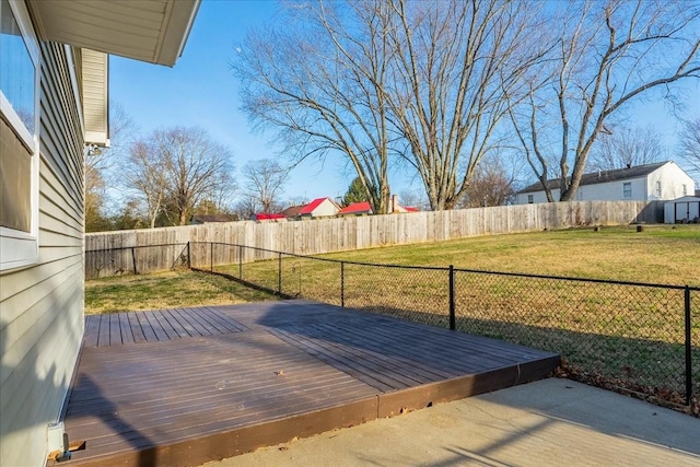 wooden terrace featuring a lawn