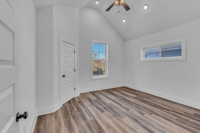 empty room featuring lofted ceiling, light hardwood / wood-style floors, and ceiling fan