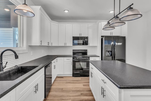 kitchen with pendant lighting, sink, black appliances, and white cabinets