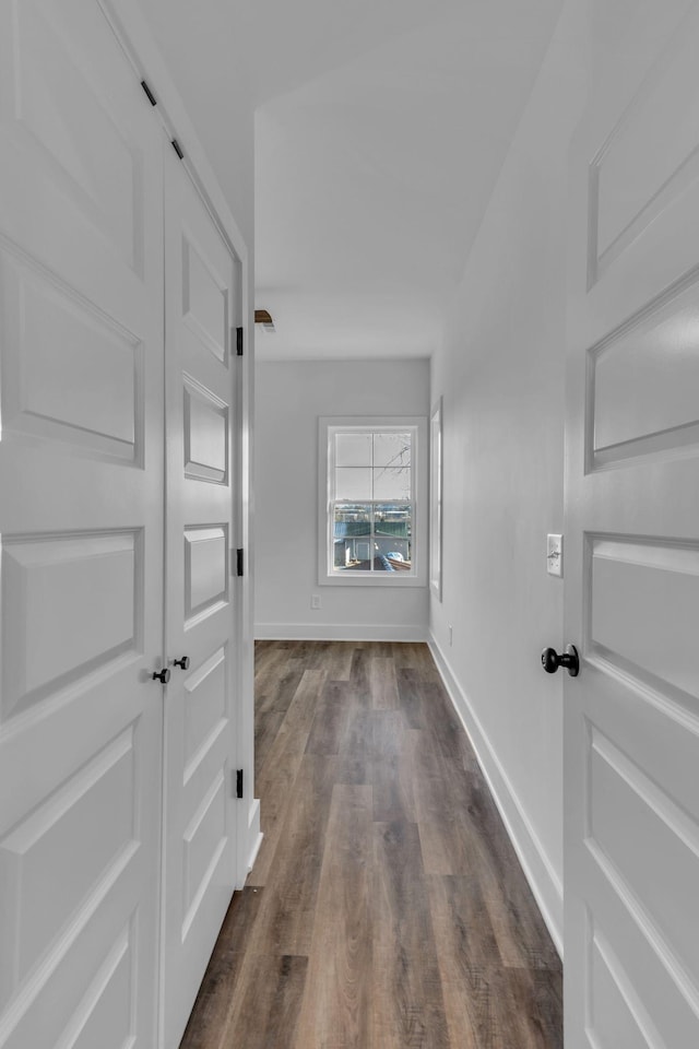 corridor with dark wood-type flooring