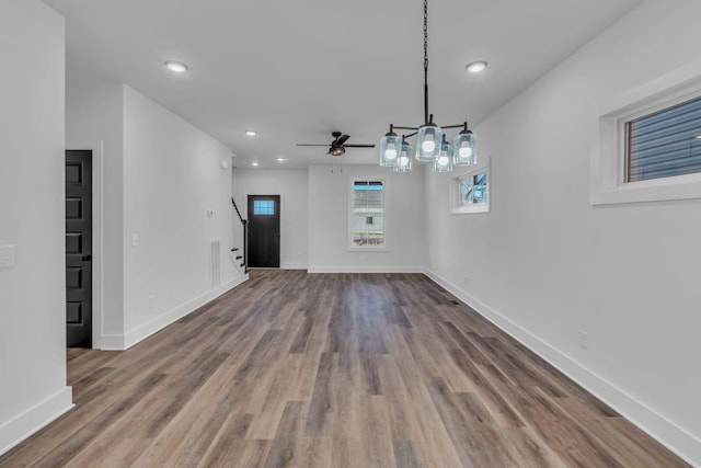 unfurnished dining area featuring hardwood / wood-style floors and ceiling fan