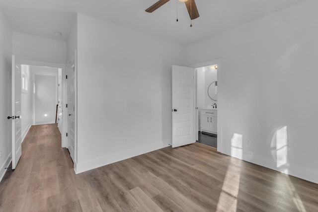 unfurnished bedroom with ceiling fan, connected bathroom, and light hardwood / wood-style floors