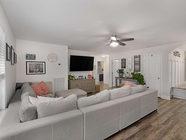 living room featuring hardwood / wood-style flooring and ceiling fan